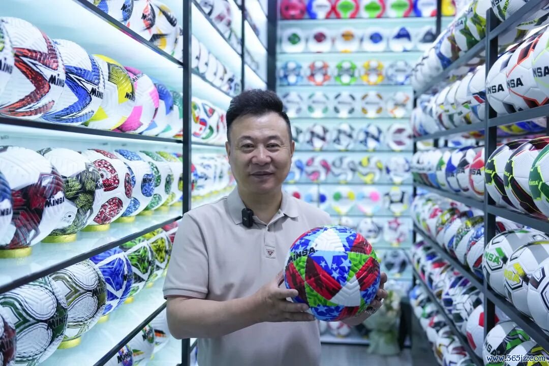 陈绍好意思展示自主策划出产的热销足球。图片开始：新华社